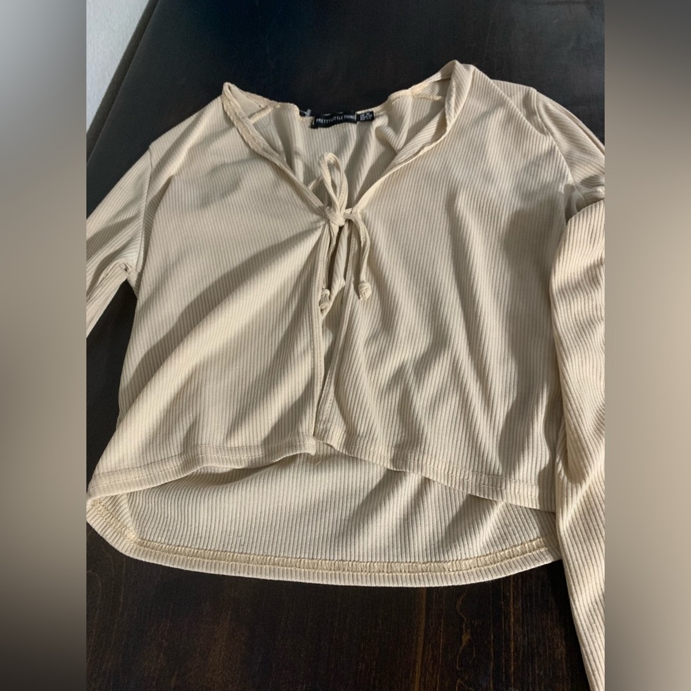 Cream colored long sleeve tie cover shirt